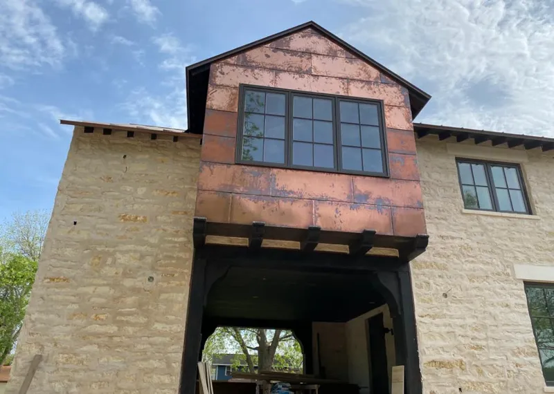 Copper metal panel facade on a stone building for Metal Roof Coating in Irving