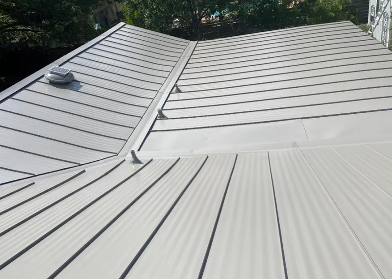Solar attic fan installed on a metal roof for Roof Ventilation in Irving